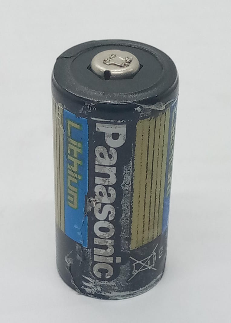 USED Product Panasonic Industrial CR123A Lithium Battery - black cylindrical battery with blue and yellow branding, shown from a slightly elevated angle.