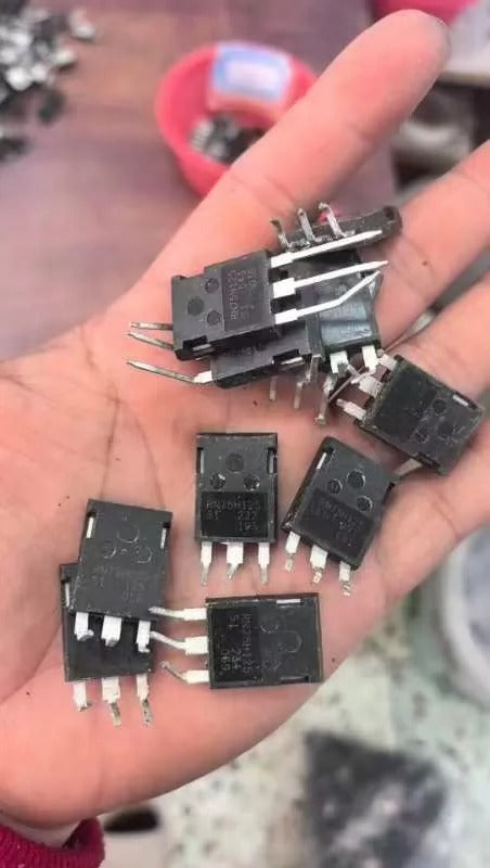 Used RN75H125 IGBT 1250V 75A High Voltage Power IGBT - a handful of black, three-pin electronic power components held in a palm.