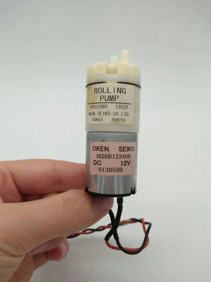 Used Suction Pump 12V DC Water Pump & Air Pump - shown as a cylindrical silver motor attached to a white plastic pump head with two small ports.