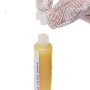 UV559 Mechanic Soldering Flux Paste UV559 No Clean BGA Solder Ball Repair Welding Paste For Phone PCB Pga SMD Rework - a yellow paste in a squeeze tube with a gloved hand removing the clear plastic cap.