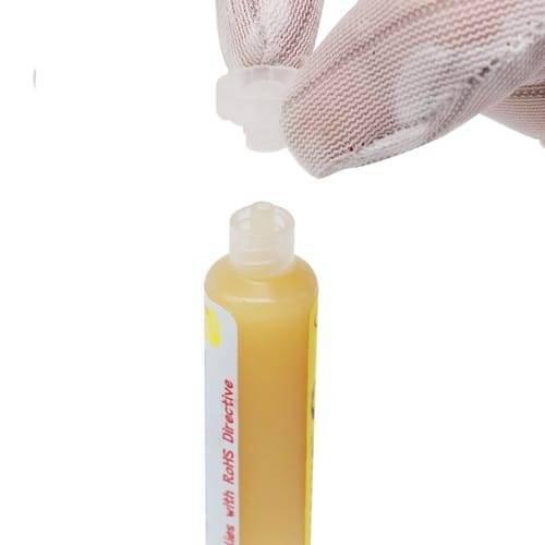 UV559 Mechanic Soldering Flux Paste UV559 No Clean BGA Solder Ball Repair Welding Paste For Phone PCB Pga SMD Rework - a yellow paste in a squeeze tube with a gloved hand removing the clear plastic cap.