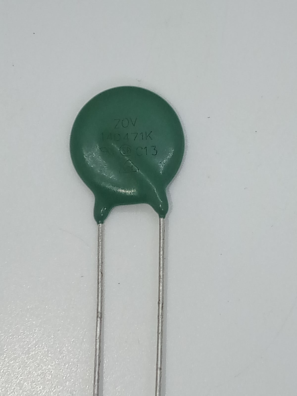 Varistor 14D471K - a green, disc-shaped electronic component with two metal leads, showing the text "ZOV 14D471K C13" printed on its surface.