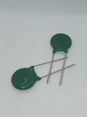 Varistor 14D471K - two green disc-shaped electronic components with two metal leads each, positioned on a white background.