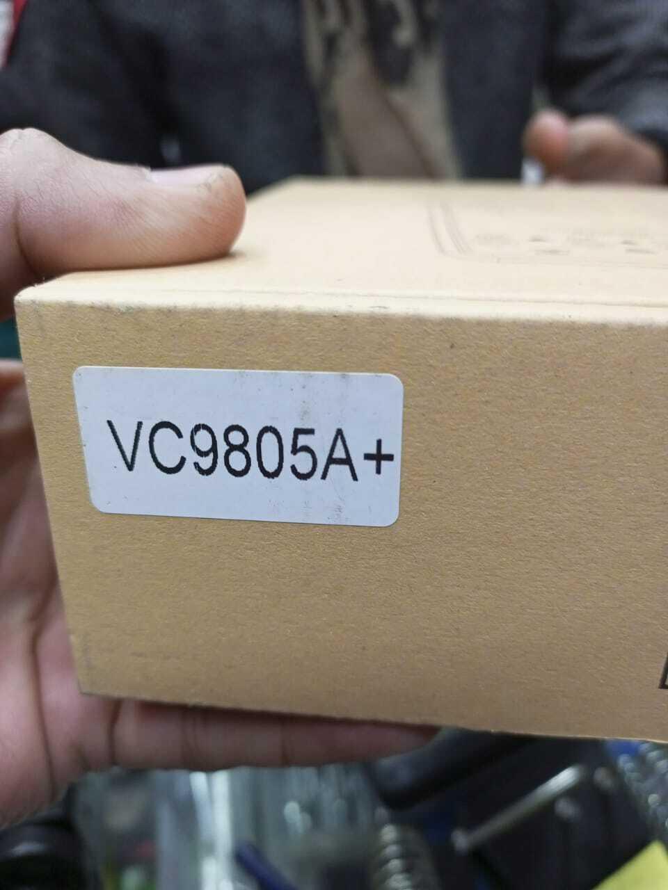 VC9805A+ Digital Multimeter - a close-up of the brown cardboard box with a white label printed with the model name.