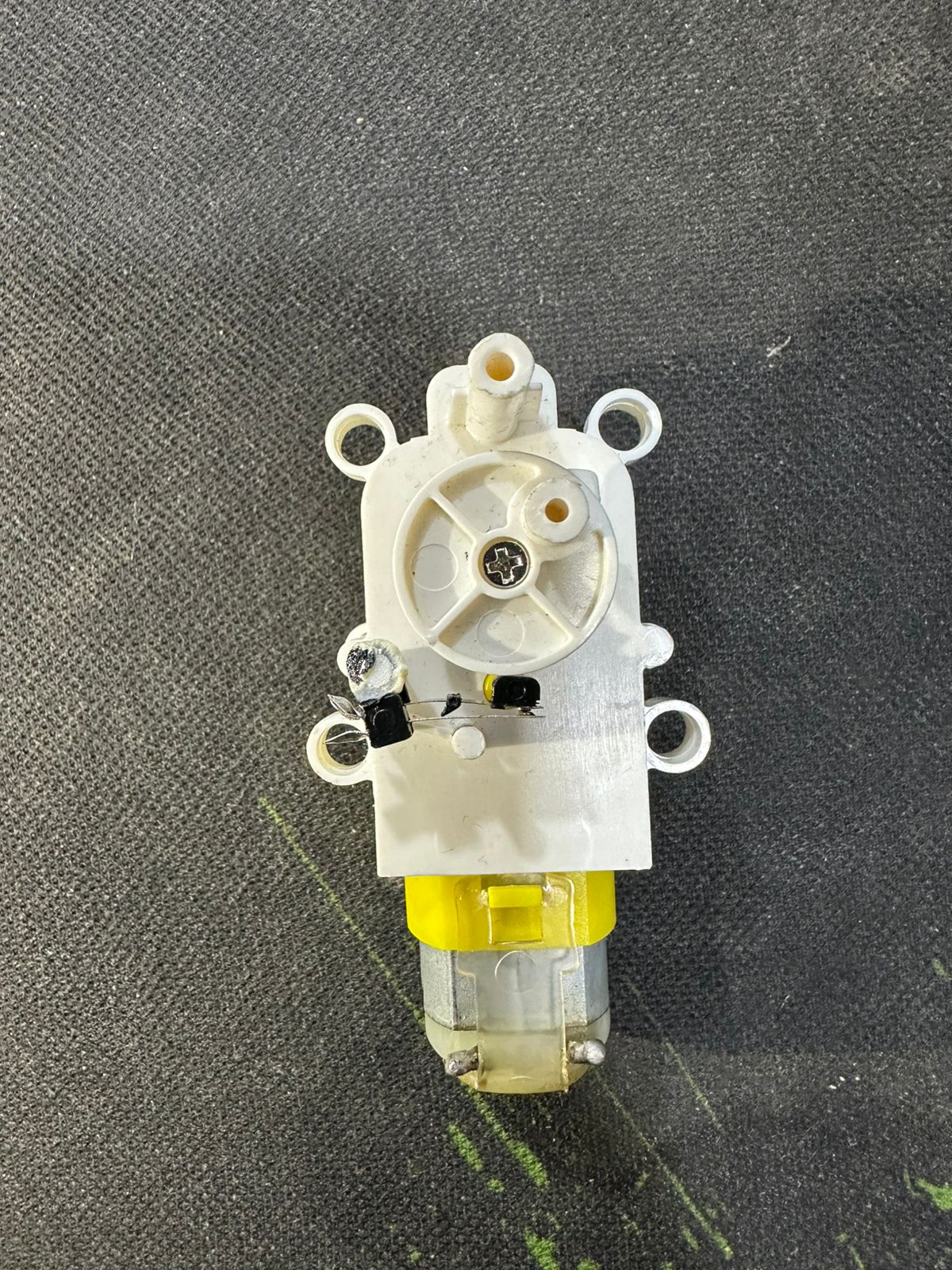 Vertical Motion TT DC Gear Motor with Cam Mechanism – Reciprocating Up-Down Movement Module for DIY Robotics & Automation - a white plastic housing with a rotating cam, two small black switches, and a yellow motor.