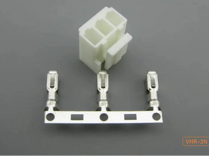 VHR Male and Female Connector Housing + THEMBEL , 3.96mm Pitch, 3 Way - a white 3-way plastic housing and three metal crimp terminals arranged in a row on a metal strip against a grey background.