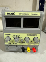 VOLDER 1502DD+ Regulated DC Power Supply - VOLDER PS-1502DD+ DC power supply in a grey casing with two blank digital displays, voltage and current control knobs, and black, yellow, and red terminals.