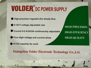 VOLDER 1502DD+ Regulated DC Power Supply - white cardboard with red and green text listing technical specifications.