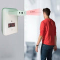 Wall Mounted Thermal Scanner ( Wall Mounted Temperature Scanner) Yna-800 - a white wall-mounted device with a red digital display, shown measuring the temperature of a man from 5-10cm away.