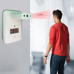 Wall Mounted Thermal Scanner ( Wall Mounted Temperature Scanner) Yna-800 - a white wall-mounted device with a red digital display, shown measuring the temperature of a man from 5-10cm away.