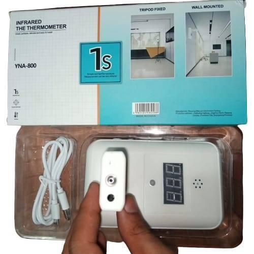 Wall Mounted Thermal Scanner ( Wall Mounted Temperature Scanner) Yna-800 - the device and a white charging cable in a plastic tray beneath its blue and white retail box.