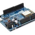 Wemos D1 R1 WiFi ESP8266 Development Board - a blue rectangular circuit board featuring a power jack, micro USB port, reset button, and pin headers.