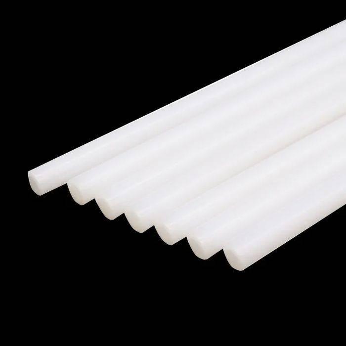 White Color 11mm Hot Melt Glue Sticks Electric Heating Adhesive Film Craft Glue Stick - a close-up of several cylindrical white adhesive sticks arranged in a row against a black background.