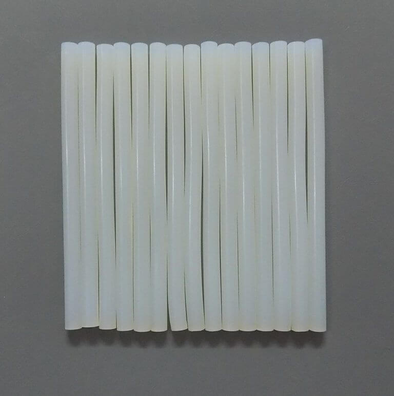 White Hot Glue Gun Sticks 7mm Length 8 to 10 Inch Approx - shown as a collection of twelve white, cylindrical glue sticks arranged side-by-side.