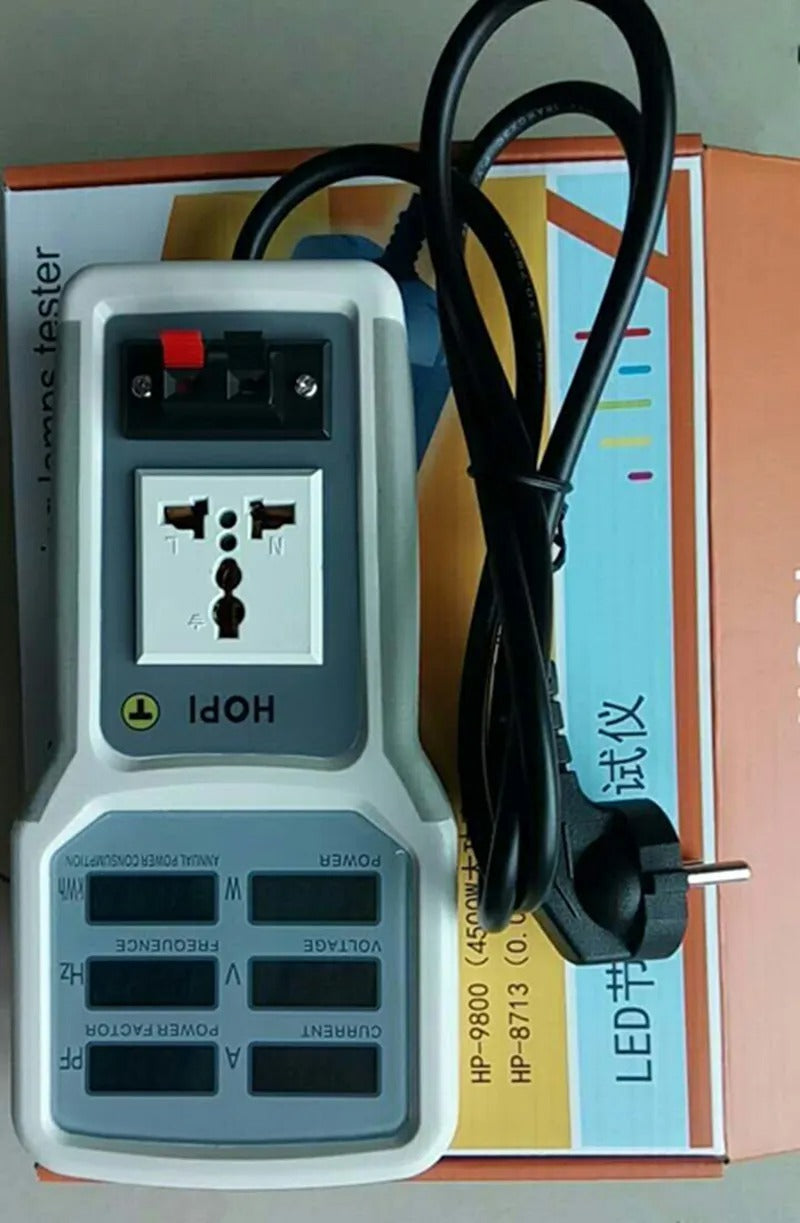 Wholesale HOPI HP-9800 Handheld Power Meter | Power Analyzer & LED Tester | Digilog.pk - a grey handheld tester with a universal power socket, red and black terminals, and six blank LCD screens, resting on its box.
