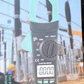 Winrpex VC902 AC 1000V Digital Clamp Meter pricein pakistan - its retail packaging box, showing the grey and teal device with a rotary dial, display, and input ports.