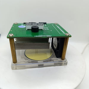 Wireless Charger Tester Smart Watches QI Wireless Charger Tester Voltage Current Load PCB Detector for Apple iWatch Galaxy Watch Wireless Chargers - a green PCB board with a digital display, a black buzzer, and a cooling fan, mounted on brass standoffs over a circular base.