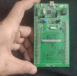 Without LCD Display STM32F429 439 Arm Cortex M4 Development Kit - shown as a green circuit board held in a hand, featuring a USB port, two buttons, and pin headers.