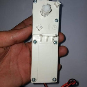 Worm Gear High Torque 12V 5RPM DC Gear Motor - a close-up of the white plastic rectangular motor housing with a protruding gear shaft and wires.