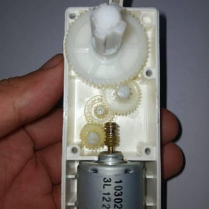 Worm Gear High Torque 12V 5RPM DC Gear Motor - a close-up view of the internal white plastic gear train and the attached metal DC motor.