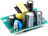 XH-M299 AC-DC Switching Power Supply Module - a green circuit board with a yellow transformer, three electrolytic capacitors, and L, N, and +5V ports.