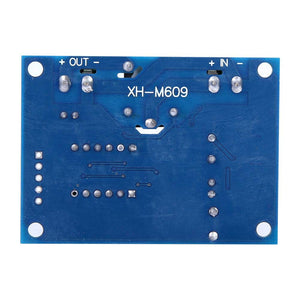 XH-M609 Low Voltage Disconnect Module 12-36V for Arduino in Pakistan - a blue rectangular circuit board showing the underside with solder points and labeled IN and OUT terminals.