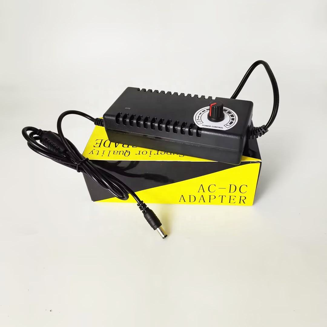 XR-F315 AC DC Power Adapter AC100-240V 3-15V 10A with Potentiometer Adjustable for Motor - black rectangular body, a rotary power control knob on top, and a DC output cable, resting on its yellow and black box.