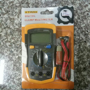 XT-MAX DT830L Digital Multimeter - in yellow and black, shown in its original retail packaging with a blank display, rotary dial, ports, and test leads.