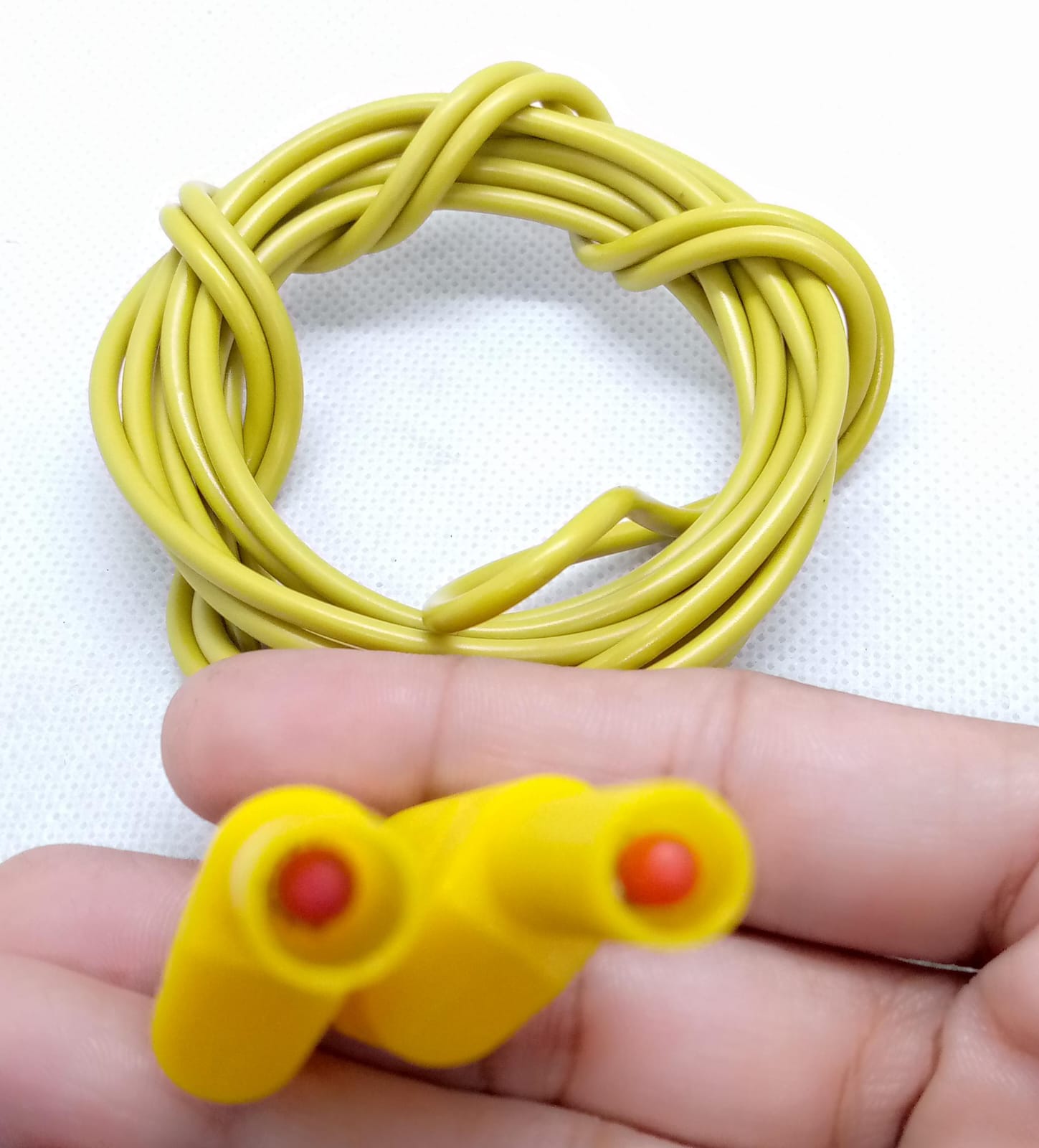 Yellow Banana Clip Wires 2 Meter | High-Quality Test Leads | Digilog.pk - with two yellow banana plug connectors held in a hand.