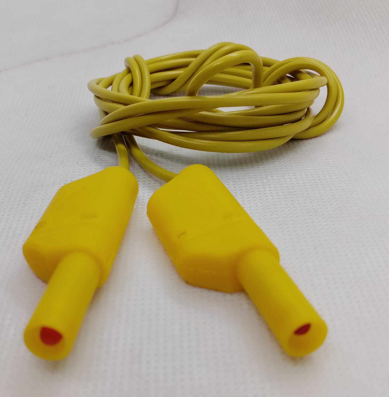 Yellow Banana Clip Wires 2 Meter | High-Quality Test Leads | Digilog.pk - a coiled yellow cable with two yellow shrouded banana plug connectors on a white background.