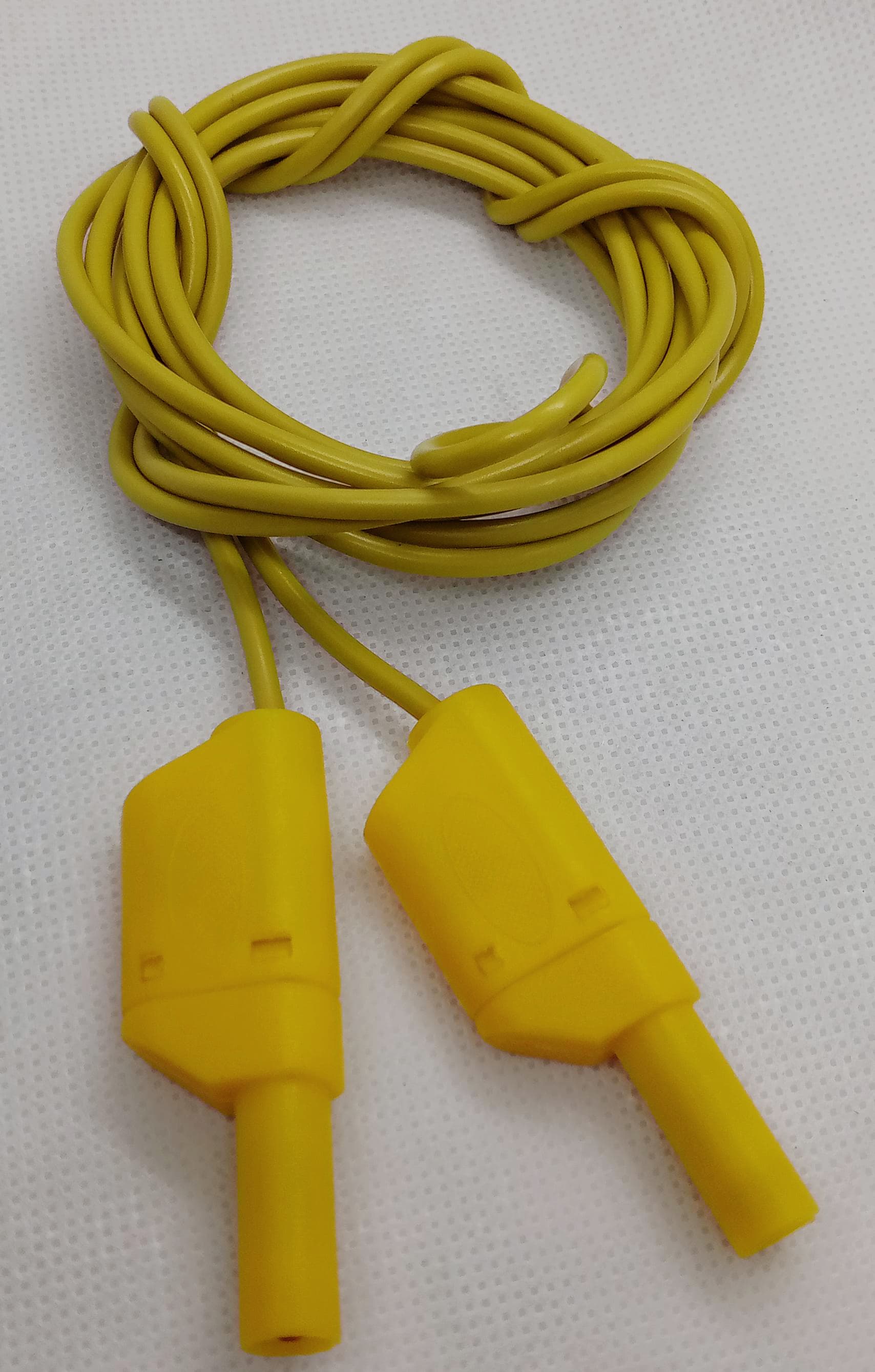 Yellow Banana Clip Wires 2 Meter | High-Quality Test Leads | Digilog.pk - a coiled yellow cable with two yellow shrouded banana plug connectors on a white textured background.