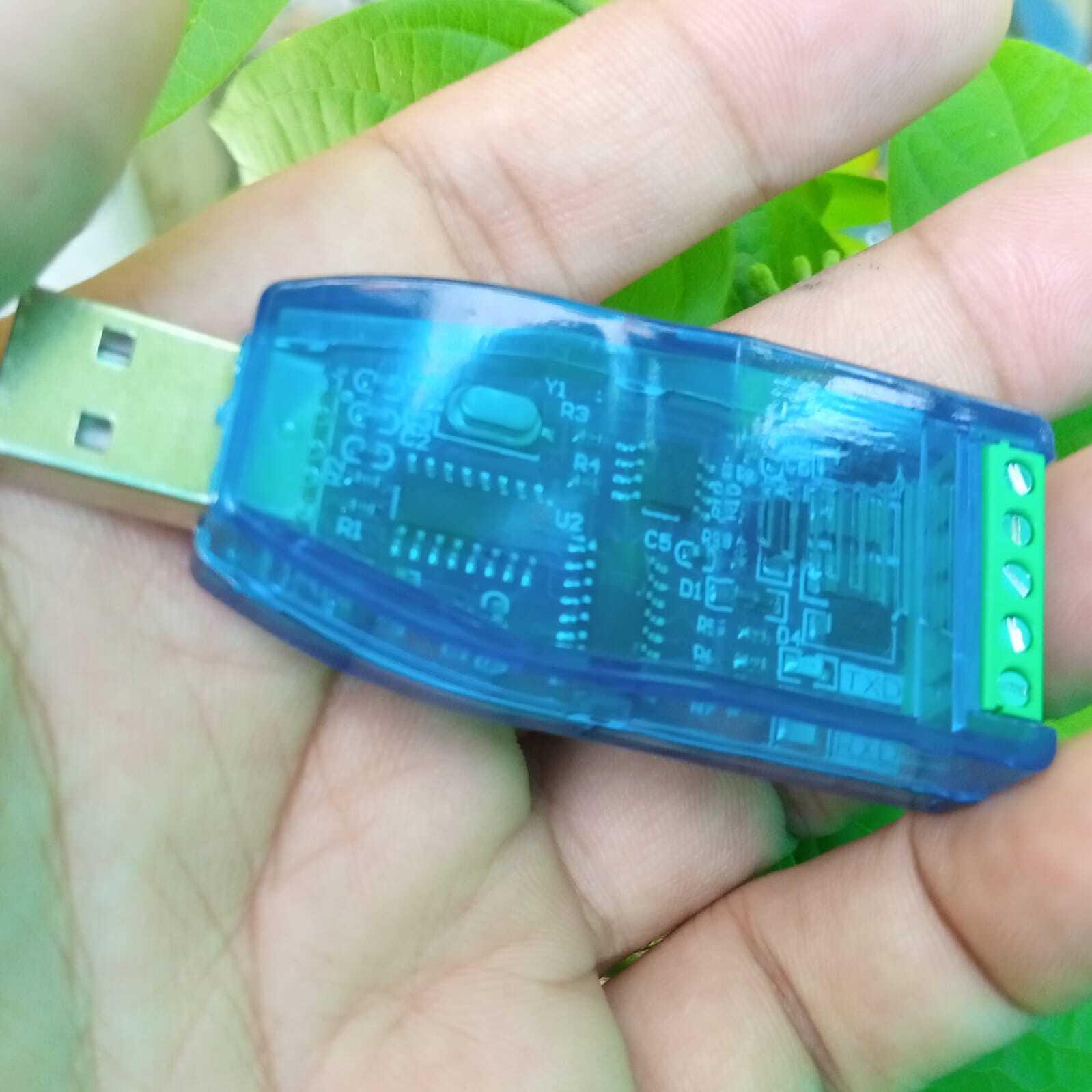 ZK-U485 Industrial Grade USB To RS485 Converter Module - blue transparent plastic casing held in a hand, featuring a USB connector and green terminal.