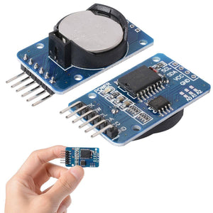 ZS 042 DS3231 Precision RTC Real Time Clock Module without cell - two blue circuit boards with pin headers, one with a battery and one held in a hand.